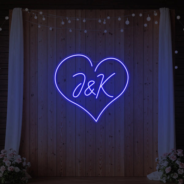 Custom wedding initials neon sign by Light Your Way, glowing pink with elegant script, perfect for wedding decor.