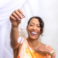 Event-ready acrylic photo keychain set with pearls, featuring colorful photo booth accessories from True Backdrops.