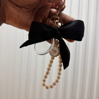 Event-ready acrylic photo keychain set with bows, featuring colorful photo booth accessories by True Backdrops.