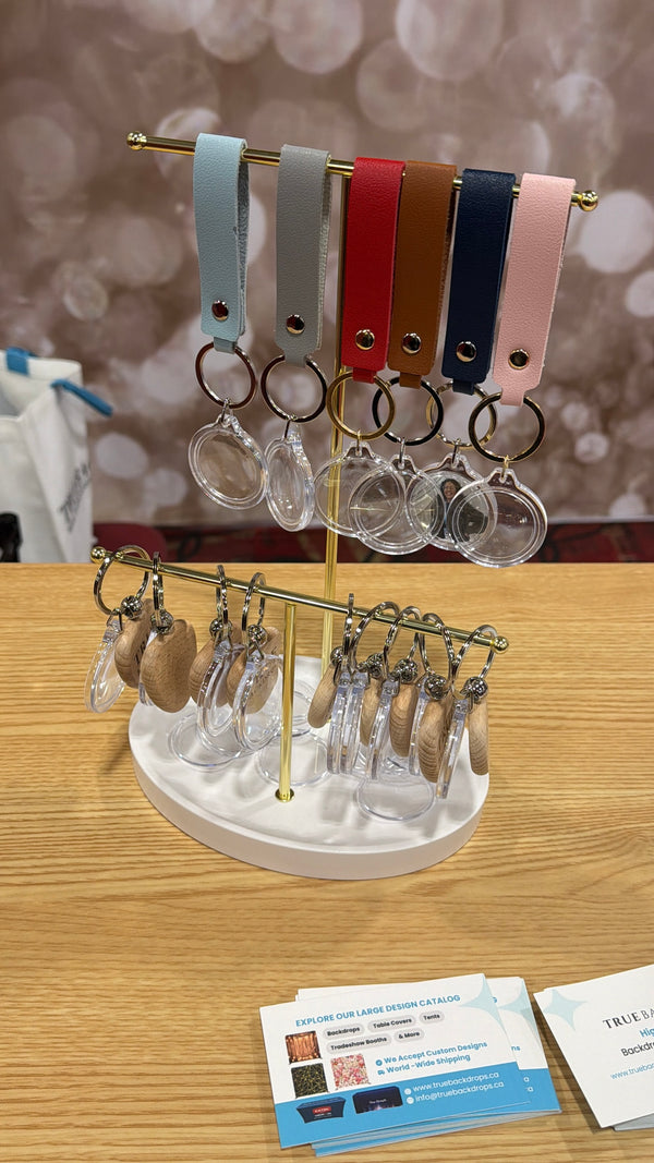 Event-ready acrylic photo keychain set with attached straps, featuring vibrant photo booth accessories from True Backdrops.