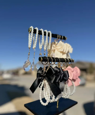 Event-ready acrylic photo keychain set with pre-assembled bows, part of True Backdrops' photo booth accessories collection.