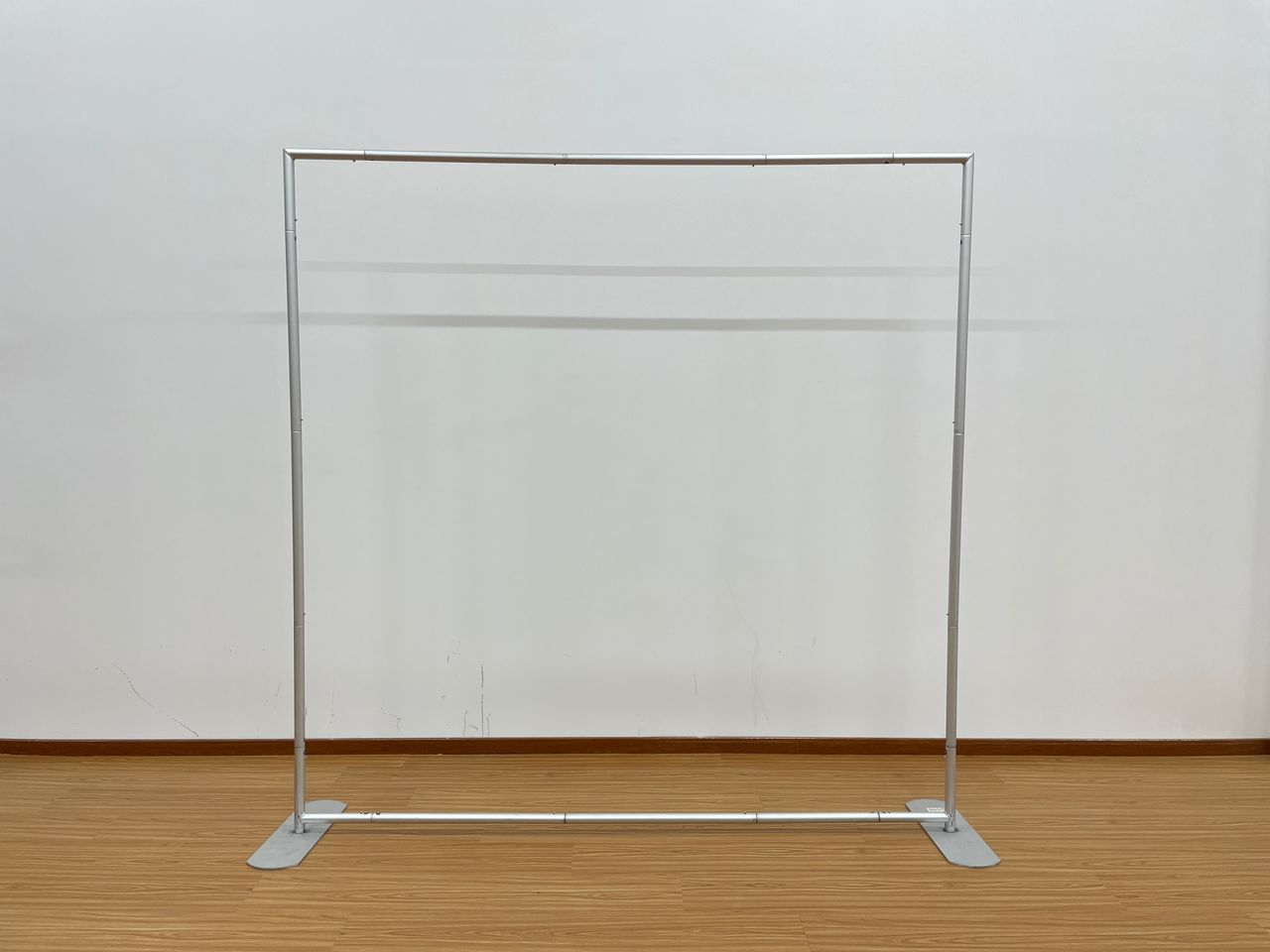 True Backdrops 8x8 backdrop stand with adjustable poles and clamps for sequin, polyester, and fabric backdrops.