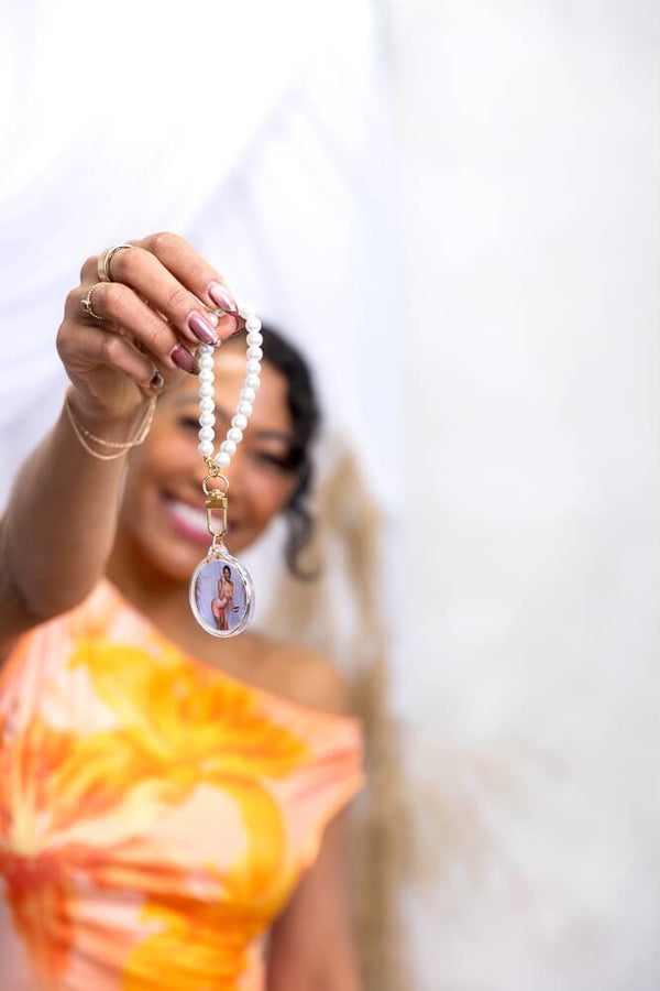 Event-ready acrylic photo keychain set by True Backdrops featuring pre-assembled photo booth accessories with pearls and decorative elements.