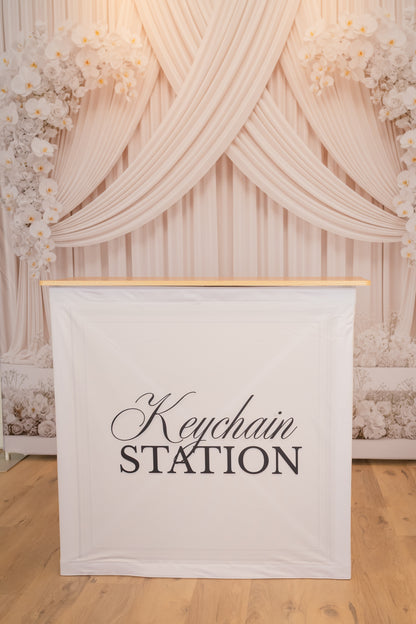 Set of 100 pre-assembled keychains with storage station from True Backdrops, displayed on a clean surface.