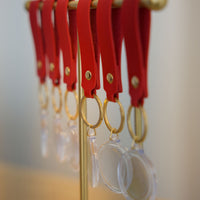 Event-ready acrylic photo keychain set with straps, featuring colorful photo booth accessories from True Backdrops.
