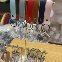 Event-ready acrylic photo keychain set with straps, featuring colorful photo booth accessories by True Backdrops.