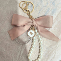 Event-ready acrylic photo keychain set with bows, featuring True Backdrops' photo booth accessories for fun photo moments.