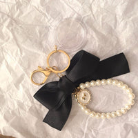 Event-ready acrylic photo keychain set from True Backdrops featuring pre-assembled photo booth accessories with bows.