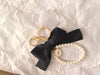 Event-ready acrylic photo keychain set from True Backdrops featuring pre-assembled photo booth accessories with bows.