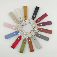 Event-ready acrylic photo keychain set with straps, featuring colorful photo booth accessories from True Backdrops.
