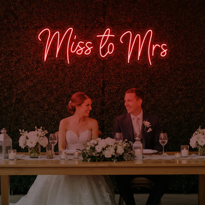 Miss to Mrs wedding neon sign by Light Your Way, featuring bright LED pink and white lettering on a neutral background