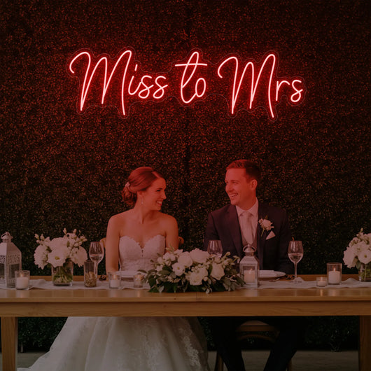 Miss to Mrs wedding neon sign by Light Your Way, featuring bright LED pink and white lettering on a neutral background