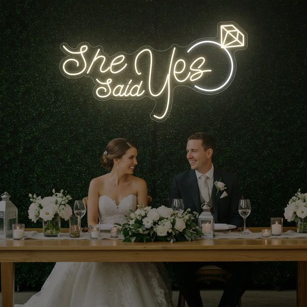 Light Your Way She Said Yes wedding neon sign with bright LED lights on a dark background, perfect for wedding decor.
