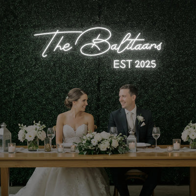 Custom wedding last names neon sign by Light Your Way, glowing romantic neon sign for wedding décor.
