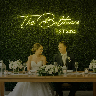 Custom wedding neon sign displaying last names in stylish light lettering, perfect for wedding decor by Light Your Way.