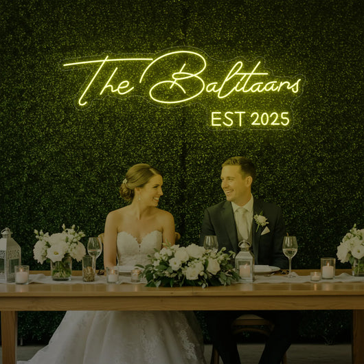 Custom wedding neon sign displaying last names in stylish light lettering, perfect for wedding decor by Light Your Way.