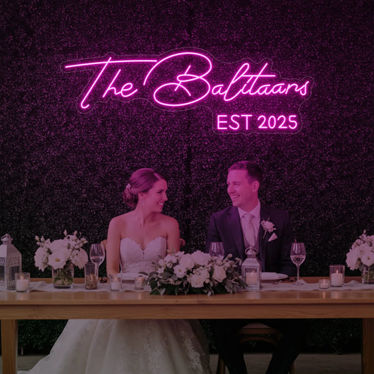Personalized wedding neon sign with custom last names in bright light, perfect for wedding decor from Light Your Way.