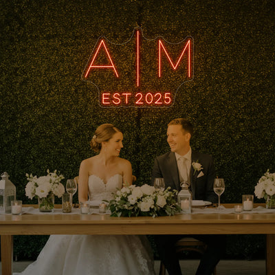 Custom neon sign with wedding initials, V4 model by Light Your Way, glowing in elegant white against a dark background.