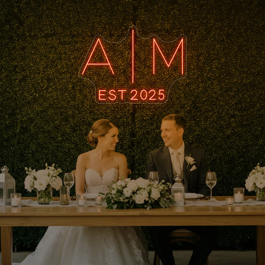 Custom neon sign with wedding initials, V4 model by Light Your Way, glowing in elegant white against a dark background.