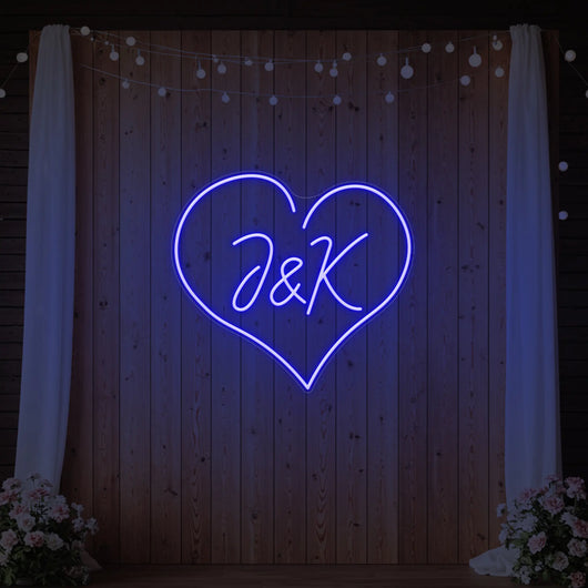 Custom wedding initials neon sign by Light Your Way, glowing pink with elegant script, perfect for wedding decor.