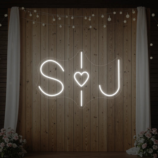 Custom neon sign for weddings with initials, illuminated in vibrant colors, by Light Your Way, perfect for wedding decor.