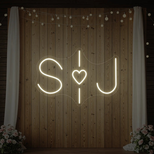 Custom wedding initials neon sign by Light Your Way with glowing initials on a dark background, perfect for wedding decor.