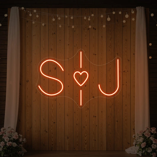 Custom wedding initials neon sign in bright white with elegant cursive style, designed by Light Your Way.