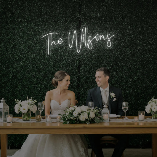 Wedding Last Names Custom Neon Sign by Light Your Way, showcasing illuminated personalized wedding decor on a sleek black background.