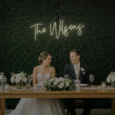 Custom wedding last names neon sign by Light Your Way, featuring personalized neon lettering for wedding decor.
