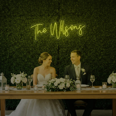 Custom wedding last names neon sign by Light Your Way, showcasing illuminated personalized wedding decor on a sleek black background.