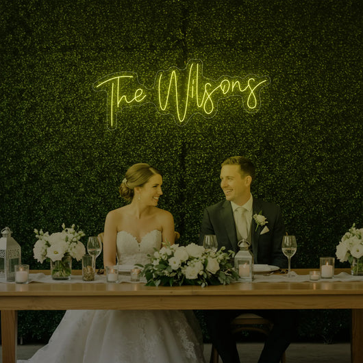 Custom wedding last names neon sign by Light Your Way, showcasing illuminated personalized wedding decor on a sleek black background.