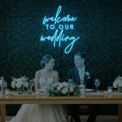 Light Your Way wedding neon sign reading "Welcome To Our Wedding V2" with bright LED illumination on a dark background.